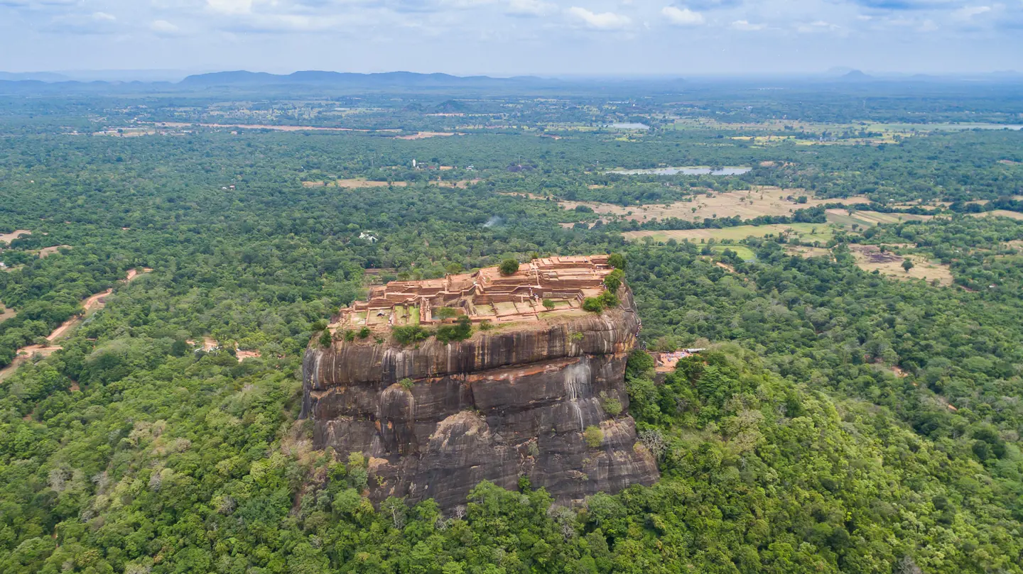 Aerial view of Sigiriya rock fortress surrounded by forest in Sri Lanka